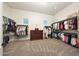 Spacious walk-in closet with built-in shelving and ample storage space and a center dresser at 20213 W Amelia Ave, Buckeye, AZ 85396