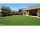 Expansive backyard featuring a well-maintained lawn and covered patio, perfect for outdoor gatherings and relaxation at 20959 W Western Dr, Buckeye, AZ 85396