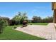 Backyard with brick patio, fireplace and grass presents a tranquil and inviting outdoor retreat at 20959 W Western Dr, Buckeye, AZ 85396