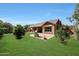 Backyard with brick patio, fireplace and grass presents a tranquil and inviting outdoor retreat at 20959 W Western Dr, Buckeye, AZ 85396