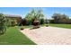 Backyard with brick patio, fireplace and grass presents a tranquil and inviting outdoor retreat at 20959 W Western Dr, Buckeye, AZ 85396