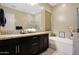 Bathroom features a double sink, granite countertops, shower and separate soaking tub at 20959 W Western Dr, Buckeye, AZ 85396