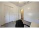 A carpeted bedroom with white walls and a closet door adds a cozy feel to the house at 20959 W Western Dr, Buckeye, AZ 85396