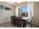 Bright dining room featuring a chandelier, large window, and a wooden table with seating for six at 20959 W Western Dr, Buckeye, AZ 85396