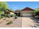Inviting home boasts a well-manicured front yard, desert landscaping and a brick paver driveway leading to a two-car garage at 20959 W Western Dr, Buckeye, AZ 85396