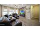 Bright and open living room featuring a wood-look accent wall, modern lighting, and comfortable leather seating at 20959 W Western Dr, Buckeye, AZ 85396