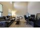 Bright office space featuring a large desk and comfortable seating area with neutral color palette at 20959 W Western Dr, Buckeye, AZ 85396