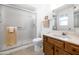 Bathroom features a frosted glass shower, tile flooring, wood vanity, and a toilet at 21222 N Aurora Dr, Sun City West, AZ 85375