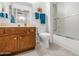 Full bathroom features tile flooring, shower, toilet, and wood vanity with a mirror at 21222 N Aurora Dr, Sun City West, AZ 85375