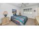 This bedroom offers comfortable accommodations with neutral carpet, a ceiling fan, and a window at 21222 N Aurora Dr, Sun City West, AZ 85375