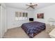 Bedroom features carpet, a ceiling fan, and a window with shutters at 21222 N Aurora Dr, Sun City West, AZ 85375
