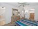 Bedroom with ceiling fan, carpet, and dresser with a large mirror at 21222 N Aurora Dr, Sun City West, AZ 85375