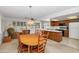 Open-concept dining area seamlessly connects to a cozy living room and functional kitchen space at 21222 N Aurora Dr, Sun City West, AZ 85375