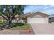 Charming single-story home with a well-manicured lawn and mature tree in a tranquil neighborhood at 21222 N Aurora Dr, Sun City West, AZ 85375