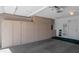 Spacious garage with ample storage cabinets, a clean epoxy floor, and an organized utility area at 21222 N Aurora Dr, Sun City West, AZ 85375