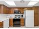 Functional kitchen with updated appliances, ample cabinet space, and bright, natural lighting from the window at 21222 N Aurora Dr, Sun City West, AZ 85375