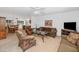 Inviting living room with comfortable seating, a ceiling fan, and seamless flow into the dining area at 21222 N Aurora Dr, Sun City West, AZ 85375