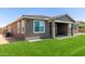 Backyard featuring artificial grass, a covered patio, and low-maintenance landscaping at 22386 N Daniel Dr, Maricopa, AZ 85138