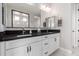 Elegant bathroom featuring double sink vanity, granite countertop, modern fixtures, and a spacious, framed mirror at 22386 N Daniel Dr, Maricopa, AZ 85138