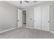 Bedroom featuring gray carpet and doorways with white doors, bright and airy at 22386 N Daniel Dr, Maricopa, AZ 85138