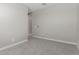 Neutral bedroom featuring gray carpet and a doorway to another room at 22386 N Daniel Dr, Maricopa, AZ 85138