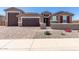 Inviting single-Gathering home with charming exterior and three car garage, featuring desert landscaping at 22386 N Daniel Dr, Maricopa, AZ 85138