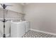 Well-lit laundry room featuring a side-by-side washer and dryer and decorative tile floors at 22386 N Daniel Dr, Maricopa, AZ 85138
