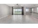 Bright, open living room with large windows and modern tile flooring offers seamless indoor-outdoor living at 22386 N Daniel Dr, Maricopa, AZ 85138