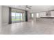 Bright and airy living space featuring luxury tile flooring, modern lighting, and seamless access to outdoor living at 22386 N Daniel Dr, Maricopa, AZ 85138