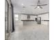 Sunlit open floor plan showcasing modern kitchen, living area, and sleek tile flooring at 22386 N Daniel Dr, Maricopa, AZ 85138