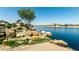 Scenic canal view with artistic rock formations and lush landscaping, adding charm to the residential community at 22386 N Daniel Dr, Maricopa, AZ 85138