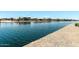 Calm canal waters reflecting charming waterfront homes, offering a picturesque and tranquil residential setting at 22386 N Daniel Dr, Maricopa, AZ 85138