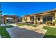 Beautifully landscaped backyard featuring artificial grass, a pergola with a dining set, and a covered patio with seating at 22601 E Via Las Brisas --, Queen Creek, AZ 85142