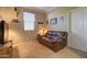 This bedroom features a comfortable leather sofa and a flat-screen TV above a rustic cabinet at 22601 E Via Las Brisas --, Queen Creek, AZ 85142