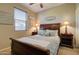 Comfortable bedroom features a wooden bedframe, decorative pillows, and bedside tables with lamps at 22601 E Via Las Brisas --, Queen Creek, AZ 85142