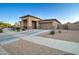 Single-story home with a two-car garage, desert landscaping, and wide driveway, offering curb appeal at 22601 E Via Las Brisas --, Queen Creek, AZ 85142