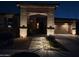 Inviting home exterior with walkway lighting and a cozy, covered front porch at 22601 E Via Las Brisas --, Queen Creek, AZ 85142