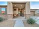 Inviting covered front porch with space for seating, complemented by brick accents at 22601 E Via Las Brisas --, Queen Creek, AZ 85142