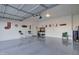 Spacious garage with epoxy floors, adorned with wall decor and a table with chairs at 22601 E Via Las Brisas --, Queen Creek, AZ 85142