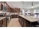 Open-concept kitchen with granite countertops, stainless appliances, and access to the dining area at 22601 E Via Las Brisas --, Queen Creek, AZ 85142