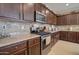 Well-equipped kitchen with stainless steel appliances, granite countertops and decorative tile backsplash at 22601 E Via Las Brisas --, Queen Creek, AZ 85142