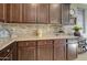Close-up view of kitchen counter with granite countertops and dark wood cabinets at 22601 E Via Las Brisas --, Queen Creek, AZ 85142