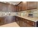 A well-appointed kitchen featuring dark wood cabinets and a granite countertop at 22601 E Via Las Brisas --, Queen Creek, AZ 85142