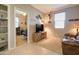 Cozy living area with wall shelves, guitar, fan, TV, and comfortable armchairs at 22601 E Via Las Brisas --, Queen Creek, AZ 85142