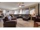 Inviting living room with leather sectional, area rug, and cozy ambiance at 22601 E Via Las Brisas --, Queen Creek, AZ 85142
