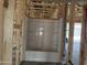 A bathroom tub and shower insert is framed with exposed construction and plumbing at 24072 W Bowker St, Buckeye, AZ 85326