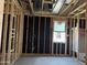 Framing and insulation for a bedroom showcasing the initial stages of construction with a window at 24072 W Bowker St, Buckeye, AZ 85326
