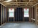 Bedroom during construction with two windows and unfinished drywall at 24072 W Bowker St, Buckeye, AZ 85326