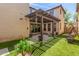 Backyard featuring a covered patio with a dining table and a porch swing, ideal for outdoor entertaining at 2435 N Riley Rd, Buckeye, AZ 85396