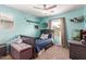 bedroom with a ceiling fan, neutral carpet, and soft aqua walls, creating a cozy and fun atmosphere at 2435 N Riley Rd, Buckeye, AZ 85396
